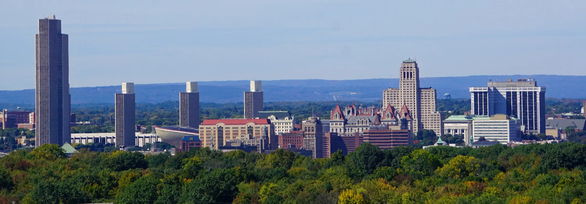 The Albany, New York skyline with the State Capitol and the Empire State Plaza towers above the trees