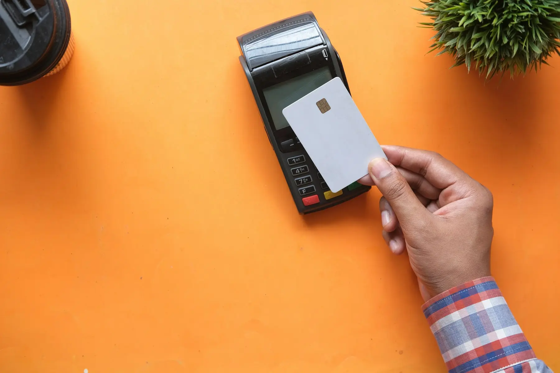 A card held near a payment terminal